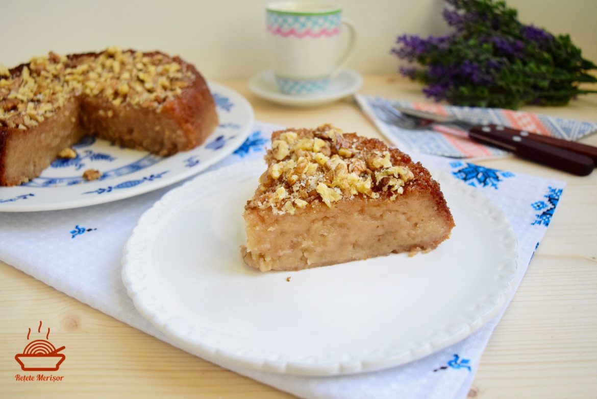 Portie de budincă de mere cu aromă de migdale și scorțișoară pe o farfurie, budinca sectionata pe platou, o ceasca de cafea si un buchet de lavanda
