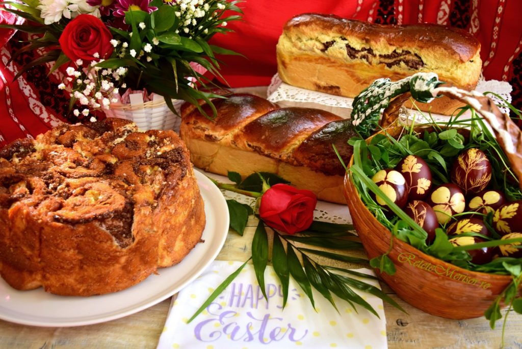 Cozonac Rosenkranz sau Cozonac cu zahăr caramelizat alături de un coș cu ouă vopsite și doi cozonaci clasici