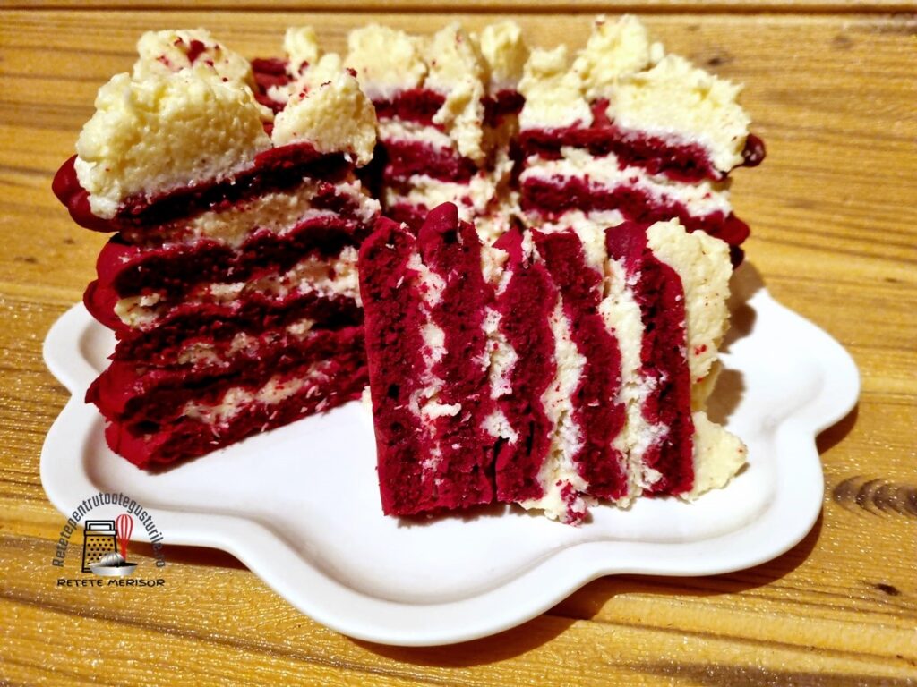Tortuleț din vafe red velvet cu cremă de cocos porționat pe un platou alb